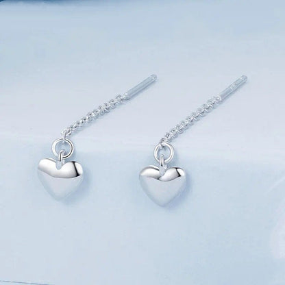Boucles d'oreilles pendantes simples en forme de cœur avec longs pompons