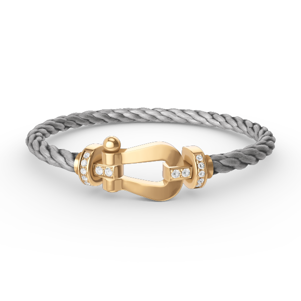 [Joyas Regalia]Pulsera de herradura grande con medio diamante en oro.