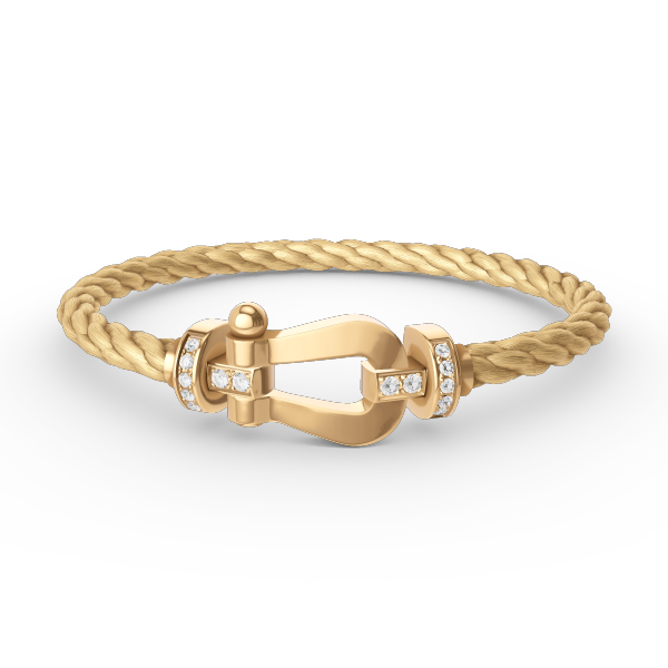 [Joyas Regalia]Pulsera de herradura grande con medio diamante en oro.