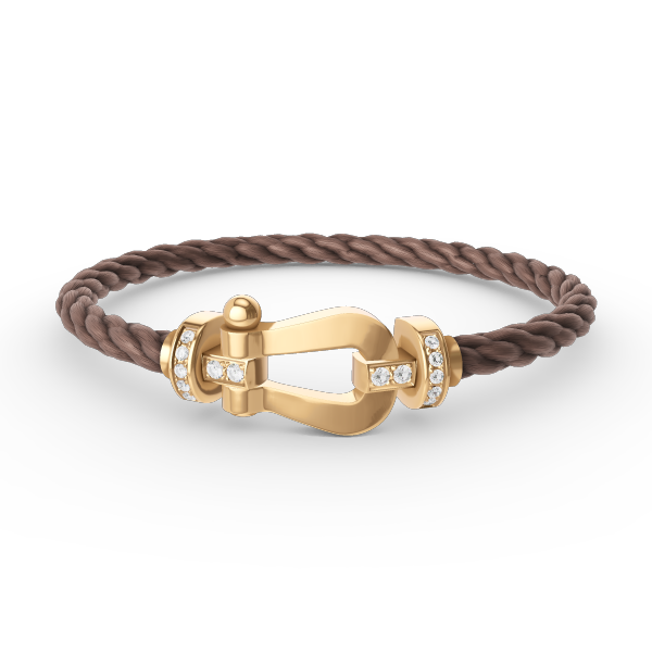 [Joyas Regalia]Pulsera de herradura grande con medio diamante en oro.