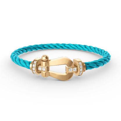 [Joyas Regalia]Pulsera de herradura grande con medio diamante en oro.