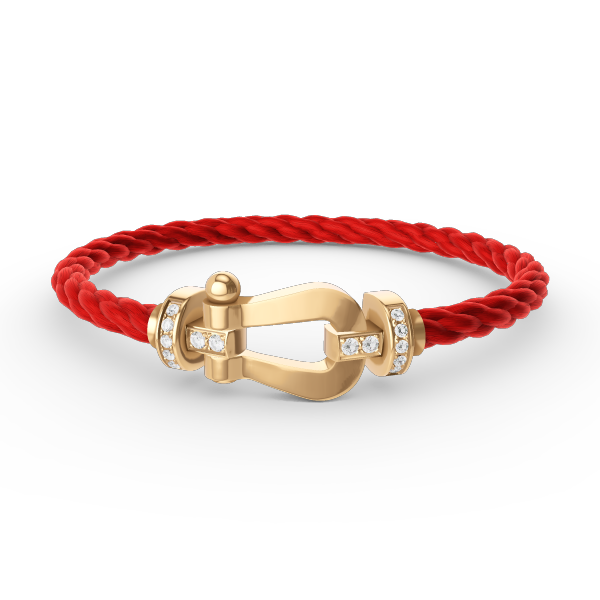 [Joyas Regalia]Pulsera de herradura grande con medio diamante en oro.