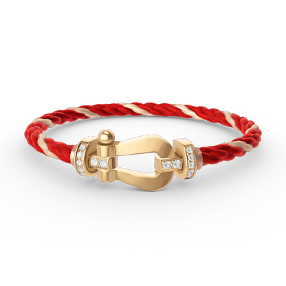 [Joyas Regalia]Pulsera de herradura grande con medio diamante en oro.