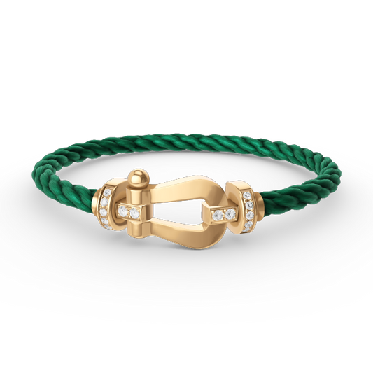 [Joyas Regalia]Pulsera de herradura grande con medio diamante en oro.