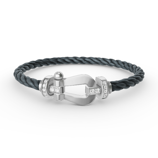 [Joyas Regalia]Pulsera de herradura grande con medio diamante en plata.