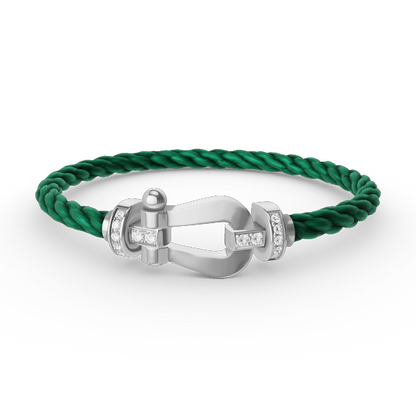 [Joyas Regalia]Pulsera de herradura grande con medio diamante en plata.